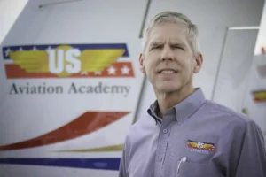 Mike Skyes, the CEO of US Aviation Academy featured in front of one of our training planes. 